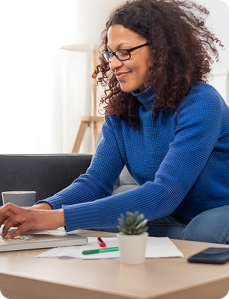 Woman with curly hair working at desk